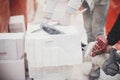 Workers cutting autoclaved aerated concrete block with chainsaw closeup. Builders cutting white blocks for masonry installation. Royalty Free Stock Photo