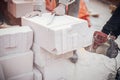 Workers cutting autoclaved aerated concrete block with chainsaw closeup. Builders cutting white blocks for masonry installation. Royalty Free Stock Photo