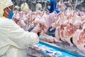 Workers are cutting chicken parts