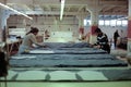 Workers cutting fabric