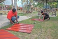 The workers is cutting a metal gazebo roof using a grinder