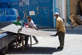 Workers cutting a still plate