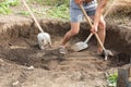 Workers dig a pit for a septic tank