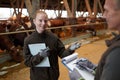 Workers Discussing Livestock at Farm