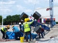 Workers Dismantle Lights on Tower Mast