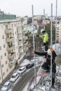 Workers dismantling temporary scaffolding wintertime