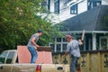 Workers Disposing of Demolition Waste