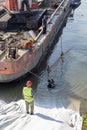 Workers and diver on revetment construction site