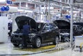 Workers doing final inspection on cars