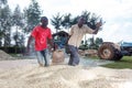 Workers drag a bag of maize