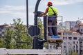 Workers at elevator platform placing surveillance camera