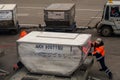Workers are employed with loading of baggage in the plane in the airport