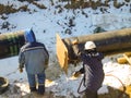 The workers engaged in the construction of the pipeline. Welders build the pipeline. Installation work in the construction and ins