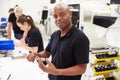 Workers In Engineering Factory Checking Component Quality Royalty Free Stock Photo