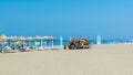 Workers equip the sand Long Beach (Velika plaza) with umbrellas brought on a tractor. Ulcinj, Montenegro. Adriatic Sea