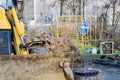 Workers excavate the pit with an excavator. Road repair.