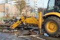 Workers excavate the pit with an excavator. Road repair.