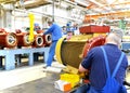 Workers in a factory assemble electric motors