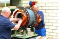 Workers in a factory assemble electric motors Royalty Free Stock Photo