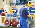 Workers in a factory assemble electric motors Royalty Free Stock Photo