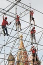Workers fix holiday decoration on the Red Square in Moscow.