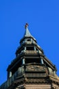 Workers fixing golden church spire of St. Peter`s church in Riga