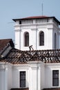 Workers fixing the tiled roof of the ancient Portuguese era Church of St. Francis of Assisi in Old