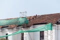 Workers fixing the tiles on the roof during the restoration of the St. Francis of Assisi church