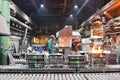 workers in a foundry casting a metal workpiece - safety at work and teamwork Royalty Free Stock Photo