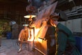 workers in a foundry casting a metal workpiece - safety at work and teamwork