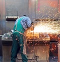 Workers in a foundry grind castings with a grinding machine - He Royalty Free Stock Photo