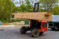 Workers in front of forklift stacker loader palette home framing beams