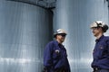 Workers and fuel storage tanks Royalty Free Stock Photo