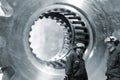 Workers with giant gears and cogwheels axles