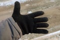 Workers hand in a black warm winter woolen glove Royalty Free Stock Photo