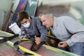 Workers hand painting steel