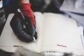 Workers hand writing in planer. Close up.