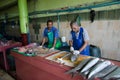 Workers handling fish on parts at fish market