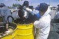 Workers handling toxic household wastes