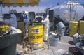 Workers handling toxic household wastes at waste cleanup site on Earth Day at the Unocal plant in Wilmington, Los Angeles, CA