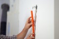 Workers hands positioning orange corrugated tube into a hole in a wall Royalty Free Stock Photo