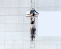 Workers hang a banner on the facade of a building, Tokyo, Japan. Copy space for text. Frame for text.