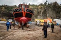 Workers in harbour launching a ship