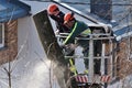 The workers with helmet working at height on the trees