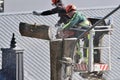 The workers with helmet working at height on the trees