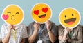 Workers holding happy face emojis Royalty Free Stock Photo