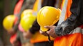 Workers Holding Safety Helmets. AI generated Royalty Free Stock Photo