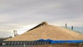 Workers hurry to cover part of the wheat harvest with tarpaulins