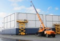 Workers install big billboard on the unfinished building supermarket. Construction crane Royalty Free Stock Photo