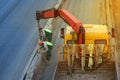 Workers install concrete fence along the road